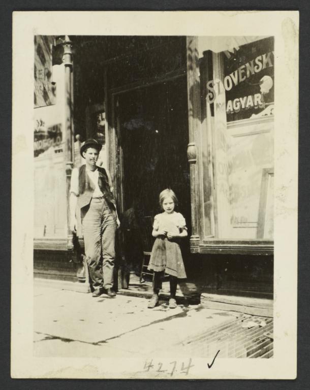 Man and Girl in Front of Shop