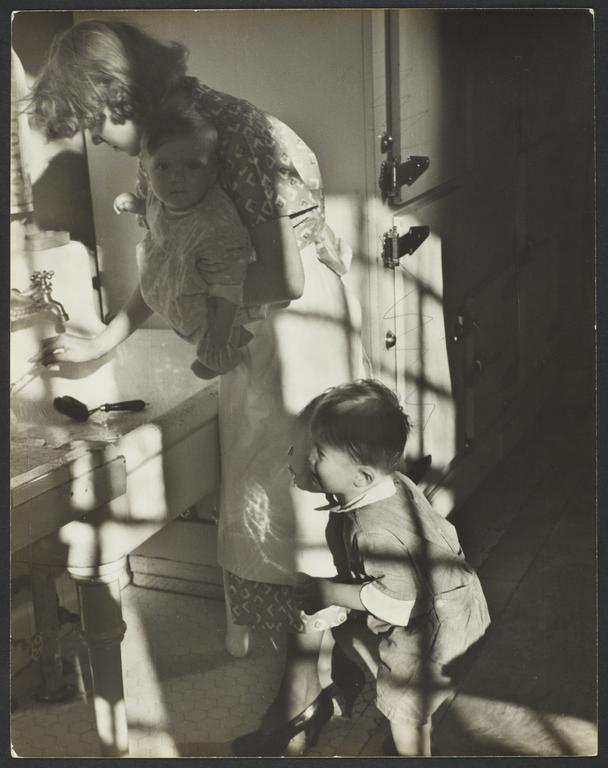 Woman with Two Children near Sink