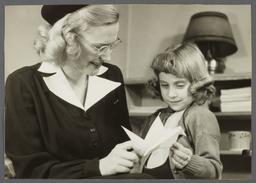 Nurses' Educational "Keep Well" Series Album -- Nurse Showing Paper Bird to Girl