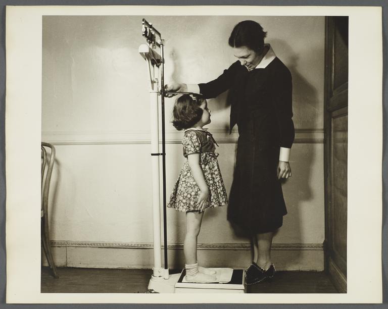 Nurses' Educational "Keep Well" Series Album -- Nurse Weighing Girl