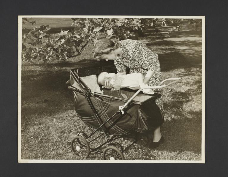 Picturing Some of the Principles of Child Care Album -- Mother Placing Baby in Carriage