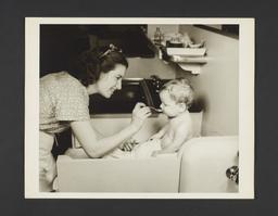 Picturing Some of the Principles of Child Care Album -- Woman Feeding Baby