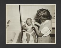 Picturing Some of the Principles of Child Care Album -- Mother Undressing Baby by Tub
