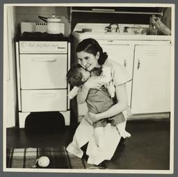 Lenox Hill, 1948-1949 Album -- Woman with Child in Kitchen