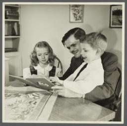 Lenox Hill, 1948-1949 Album -- Man with Two Children Reading Book