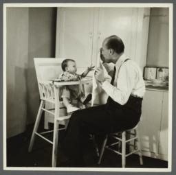 Lenox Hill, 1948-1949 Album -- Man Hiding Behind Napkin for Baby