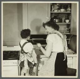 Lenox Hill, 1948-1949 Album -- Woman with Girl in Kitchen