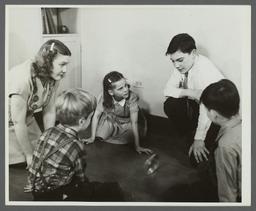 Lenox Hill, 1948-1949 Album -- Woman with Children Playing on Floor