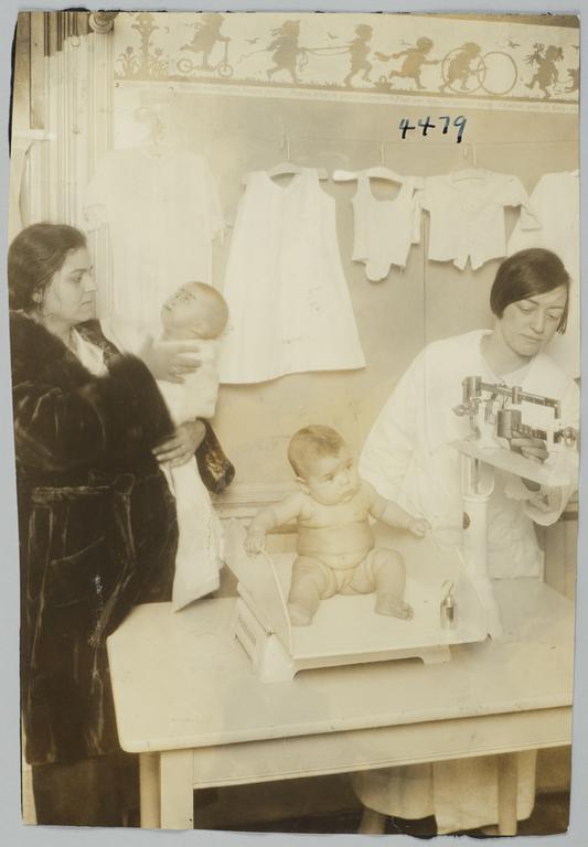 Mulberry Health Center Album -- Nurse, Mother and Two Babies at the Mulberry Health Center